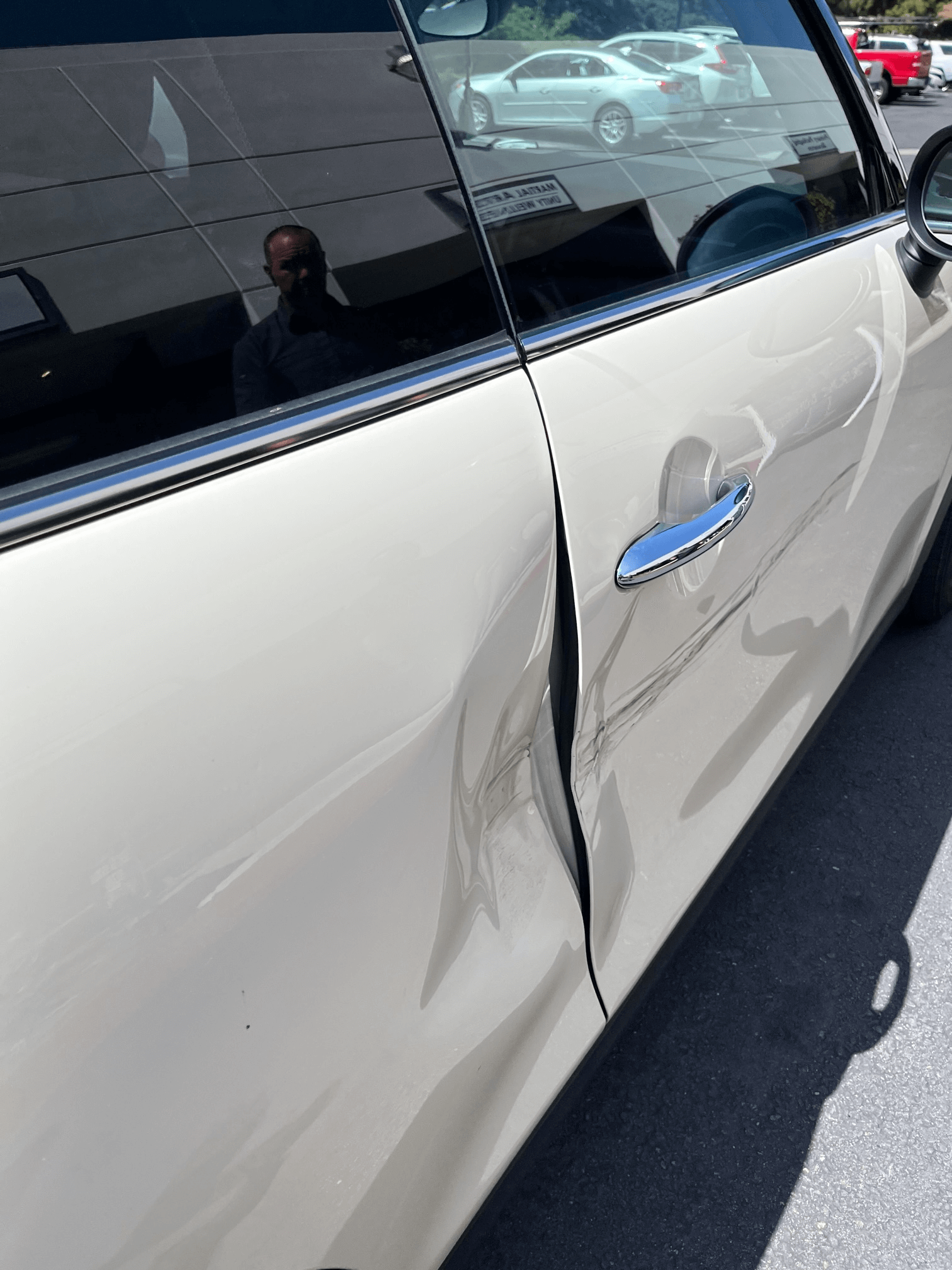 Door dent before PDR repair at Dentco Orange County
